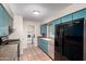 Bright kitchen featuring blue cabinets, stainless steel appliances, granite countertops and tile flooring at 4158 E Crescent Ave, Mesa, AZ 85206