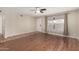 Open living room with wood floors, ceiling fan, and a front door view, offering a welcoming space at 4158 E Crescent Ave, Mesa, AZ 85206
