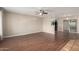 Bright living room featuring a ceiling fan, wood floors and access to the backyard via sliding glass doors at 4158 E Crescent Ave, Mesa, AZ 85206