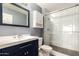 Modern bathroom featuring a glass shower, white tiled walls, and sleek vanity at 4319 E Contessa St, Mesa, AZ 85205