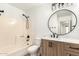 Bathroom featuring a modern vanity with a round mirror and a shower-tub combination at 4319 E Contessa St, Mesa, AZ 85205