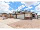 Charming home featuring a brick-accented facade, two-car garage, and low-maintenance desert landscaping at 4319 E Contessa St, Mesa, AZ 85205