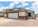 Charming single-story home featuring a spacious two-car garage and low maintenance landscaping at 4319 E Contessa St, Mesa, AZ 85205