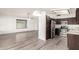 Modern kitchen featuring stainless steel appliances, dark cabinets, and an open view to the living area at 4319 E Contessa St, Mesa, AZ 85205