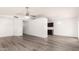 Open-concept living area featuring wood-look floors and access to the kitchen with modern finishes at 4319 E Contessa St, Mesa, AZ 85205
