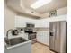Efficient kitchen with stainless steel appliances, neutral countertops, and white cabinetry at 5303 N 7Th St # 118, Phoenix, AZ 85014