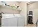 Bright laundry room with washer and dryer and storage shelves at 5303 N 7Th St # 118, Phoenix, AZ 85014