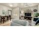 Living room featuring tile floors, a ceiling fan, a sofa, and access to the dining area at 5303 N 7Th St # 118, Phoenix, AZ 85014