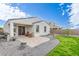 Spacious backyard featuring a covered patio and well-maintained lawn, ideal for outdoor living at 5312 W Hardtack Trl, Laveen, AZ 85339