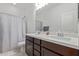 Bathroom featuring a double sink vanity, shower and tub combination, and neutral tile flooring at 5312 W Hardtack Trl, Laveen, AZ 85339