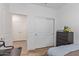 Well-lit bedroom with wood flooring, featuring a closet with sliding doors and a gray dresser at 5312 W Hardtack Trl, Laveen, AZ 85339