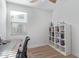 Bedroom featuring wood flooring, a window with blinds, a desk, and a white bookshelf filled with books at 5312 W Hardtack Trl, Laveen, AZ 85339