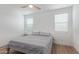 Bedroom with a ceiling fan, two windows with blinds, and wood flooring at 5312 W Hardtack Trl, Laveen, AZ 85339