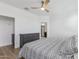 Bright bedroom with a wood ceiling fan, wood floors, a gray dresser, and white walls at 5312 W Hardtack Trl, Laveen, AZ 85339