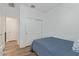This bedroom features a twin bed, closet with sliding doors, and wood-look floors at 5312 W Hardtack Trl, Laveen, AZ 85339