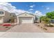 Charming single-story home with a brick driveway, a two-car garage, and desert landscaping at 5312 W Hardtack Trl, Laveen, AZ 85339