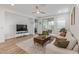 Bright living room featuring stylish décor, a ceiling fan, and sliding doors to the patio at 5312 W Hardtack Trl, Laveen, AZ 85339