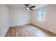 Minimalist bedroom with hardwood floors, fan, and closet, providing a clean and modern aesthetic at 576 N Pasadena --, Mesa, AZ 85201