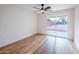 Bright bedroom features wood-look flooring, a ceiling fan, and sliding glass doors to the backyard at 576 N Pasadena --, Mesa, AZ 85201