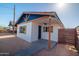 Exterior of house with blue gable, rustic wood supports, shutters and a fenced in yard at 576 N Pasadena --, Mesa, AZ 85201