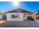 Charming home featuring a striking blue gable, wood accents, and a neatly landscaped front yard at 576 N Pasadena --, Mesa, AZ 85201