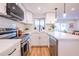 Bright, white kitchen with stainless steel appliances, quartz countertops, and modern backsplash, stylish and functional at 576 N Pasadena --, Mesa, AZ 85201