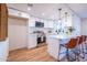Modern kitchen featuring white cabinets, stainless steel appliances, and a stylish breakfast bar with seating at 576 N Pasadena --, Mesa, AZ 85201