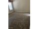 A bright bedroom featuring cozy carpeting and a large window at 5901 E Leonora St, Mesa, AZ 85215