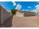 Tan single-story home showcasing a xeriscaped yard and an extended, screened-in porch area at 5901 E Leonora St, Mesa, AZ 85215
