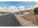 Charming one-story home with attached garage, gravel landscaping, and a street view at 5901 E Leonora St, Mesa, AZ 85215