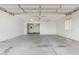 Bright and clean garage with concrete floors, white walls, window, and garage door at 5901 E Leonora St, Mesa, AZ 85215