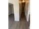 Hallway with wood floors, leading to rooms and closets at 5901 E Leonora St, Mesa, AZ 85215