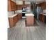 A modern kitchen featuring stainless steel appliances, an island, and lots of wood cabinets at 5901 E Leonora St, Mesa, AZ 85215