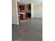 A well-lit living room flows into a kitchen with stainless steel appliances and wood cabinets at 5901 E Leonora St, Mesa, AZ 85215