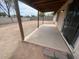 View of a covered patio area overlooking a spacious, unfinished backyard at 6231 W Zoe Ella Way, Glendale, AZ 85306