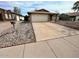 Charming single-story home with a large driveway and attached two-car garage at 6231 W Zoe Ella Way, Glendale, AZ 85306