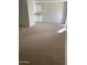 Bright and airy living room with plush carpeting and views of kitchen at 6231 W Zoe Ella Way, Glendale, AZ 85306
