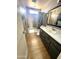 Bathroom featuring gray walls, basic vanity, and shower-tub combo at 7961 W Campbell Ave, Phoenix, AZ 85033
