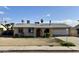 Modest one-story home with attached garage and minimal landscaping under a blue sky at 7961 W Campbell Ave, Phoenix, AZ 85033