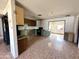 Open kitchen and dining area with vintage tiling, cabinetry, and countertops at 7961 W Campbell Ave, Phoenix, AZ 85033