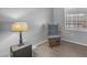 Well-lit bedroom features neutral walls, a glider chair, and sleek wood-look flooring at 8103 E Southern Ave # 205, Mesa, AZ 85209
