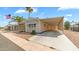 Charming manufactured home with a covered carport and manicured landscaping at 8103 E Southern Ave # 205, Mesa, AZ 85209