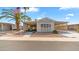 Charming single-story home with covered parking, mature landscaping, and an American flag at 8103 E Southern Ave # 205, Mesa, AZ 85209