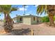 Landscaped exterior view of the home surrounded by palm trees and gravel at 8103 E Southern Ave # 268, Mesa, AZ 85209