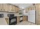 A well-lit kitchen featuring wood cabinets, black appliances, and durable countertops at 8103 E Southern Ave # 268, Mesa, AZ 85209