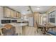 An open-concept kitchen and dining area featuring wood cabinetry and a breakfast bar at 8103 E Southern Ave # 268, Mesa, AZ 85209