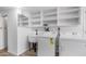 A clean laundry room with shelving, a utility sink, and modern appliances at 8103 E Southern Ave # 268, Mesa, AZ 85209