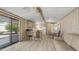 An open-concept living area featuring wood-look floors, and a sliding glass door at 8103 E Southern Ave # 268, Mesa, AZ 85209