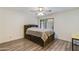 Cozy bedroom with a built-in headboard and storage, complemented by modern wood flooring at 8827 N New World Dr, Glendale, AZ 85302