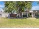 Charming single-story home with a well-manicured lawn and mature shade tree at 8827 N New World Dr, Glendale, AZ 85302